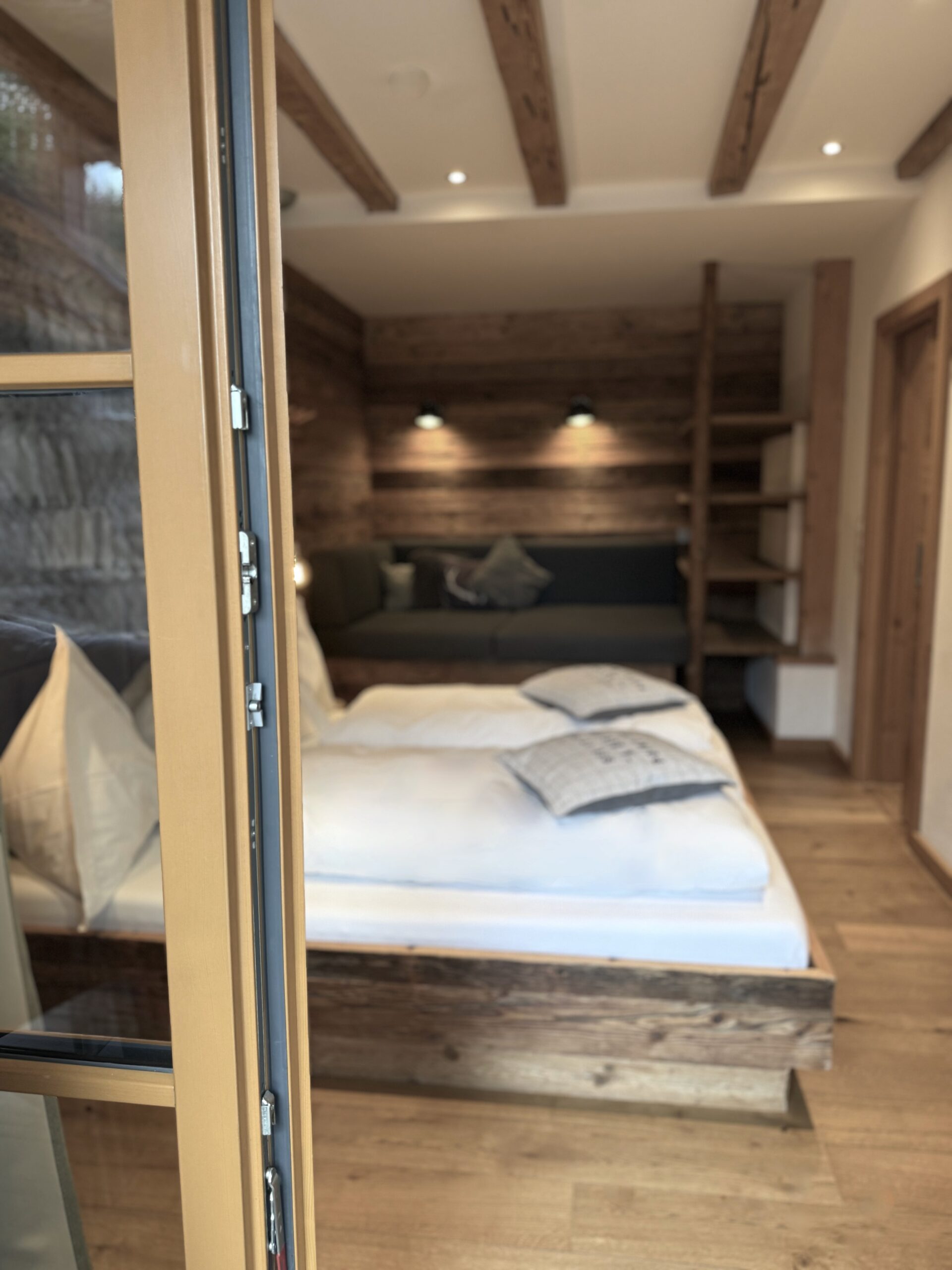 Slaapkamer met toegang tot terras in de Mandlwand Lodge